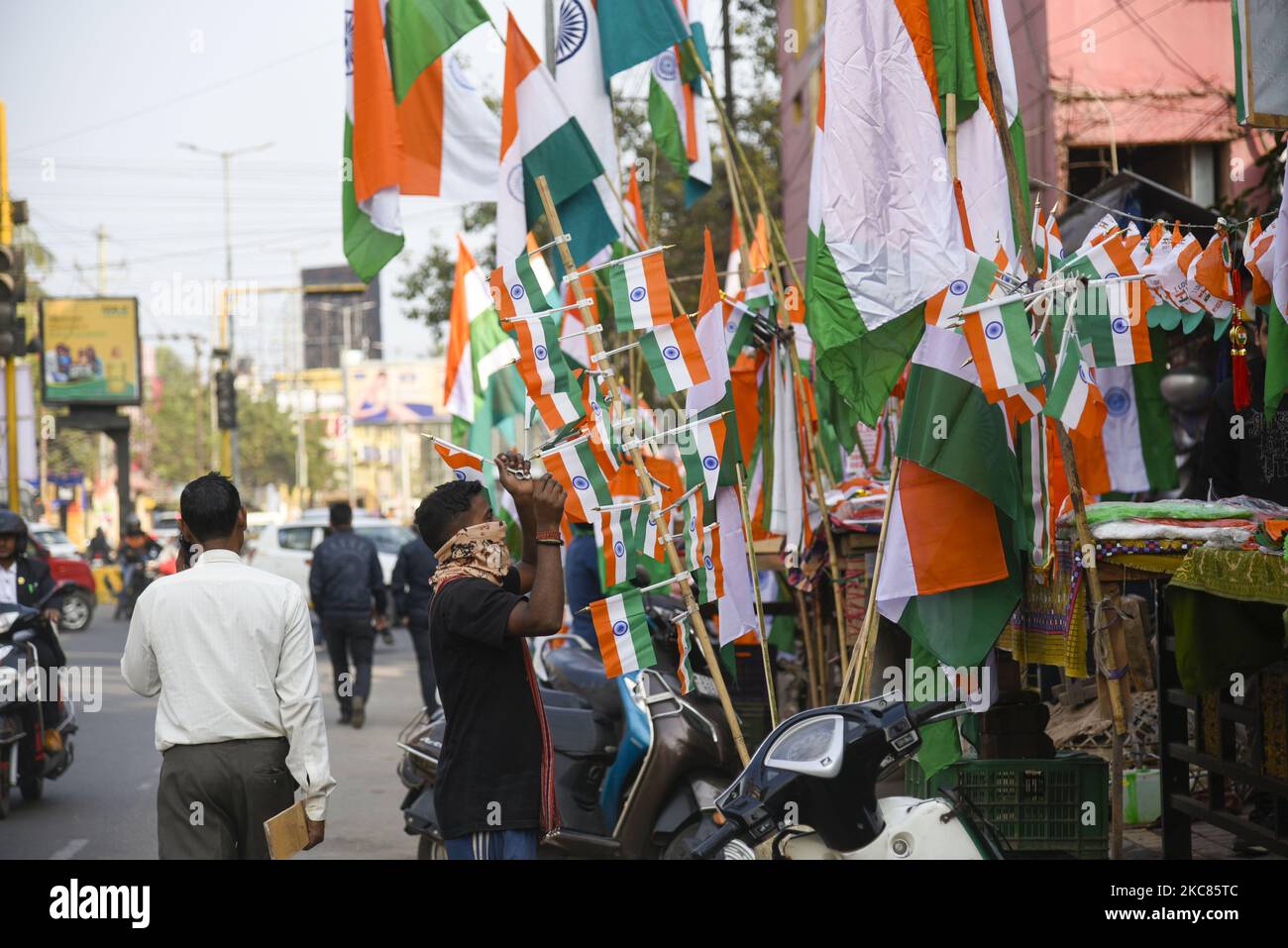 Street vendor selling tricolour in the eve of 71st Republic day, in Guwahati on 25 January 2021. Republic Day is celebrated every year in India on January 26 to commemorate the date on which the Constitution of India came into effect, in the year 1950, and the country became a republic. (Photo by David Talukdar/NurPhoto) Stock Photo