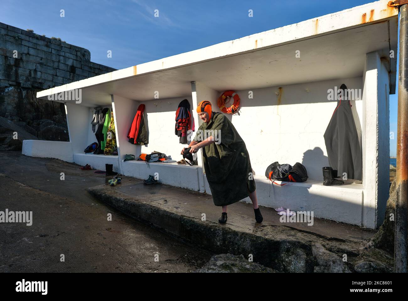 A swimmer squeezes the water out of the swimsuit after a bath at Forty