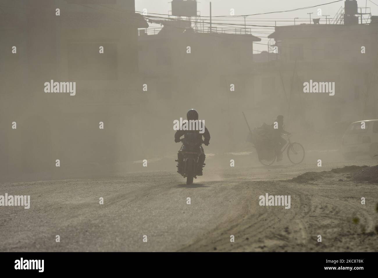 Bikers travelling through mass of dust and air pollution at Kathmandu, Nepal on Tuesday, January 26, 2021. Kathmandu has been ranked as the top 10 most polluted city in the world. (Photo by Narayan Maharjan/NurPhoto) Stock Photo