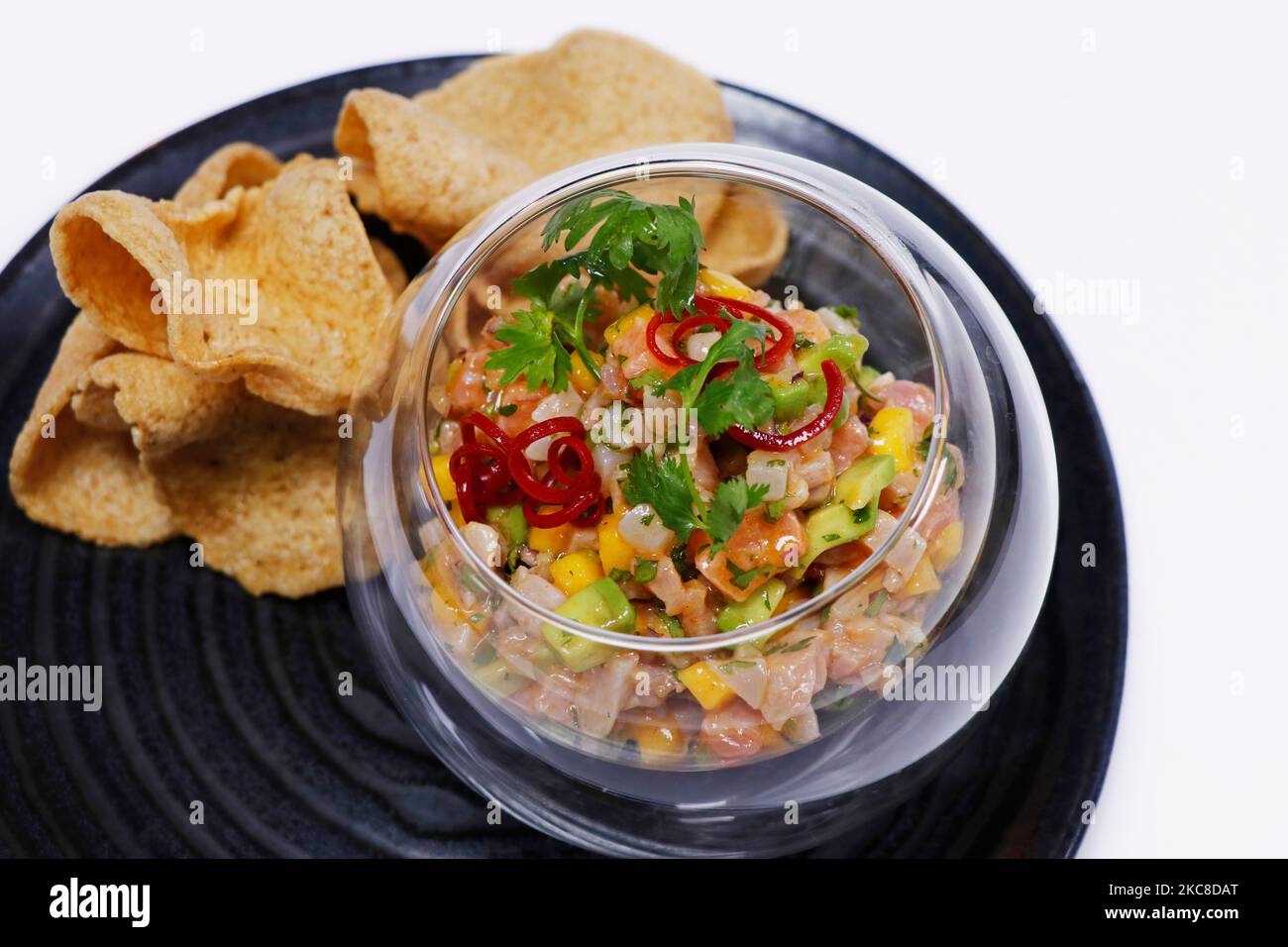 seafood ceviche or tartare in a glass bowl with crackers Stock Photo