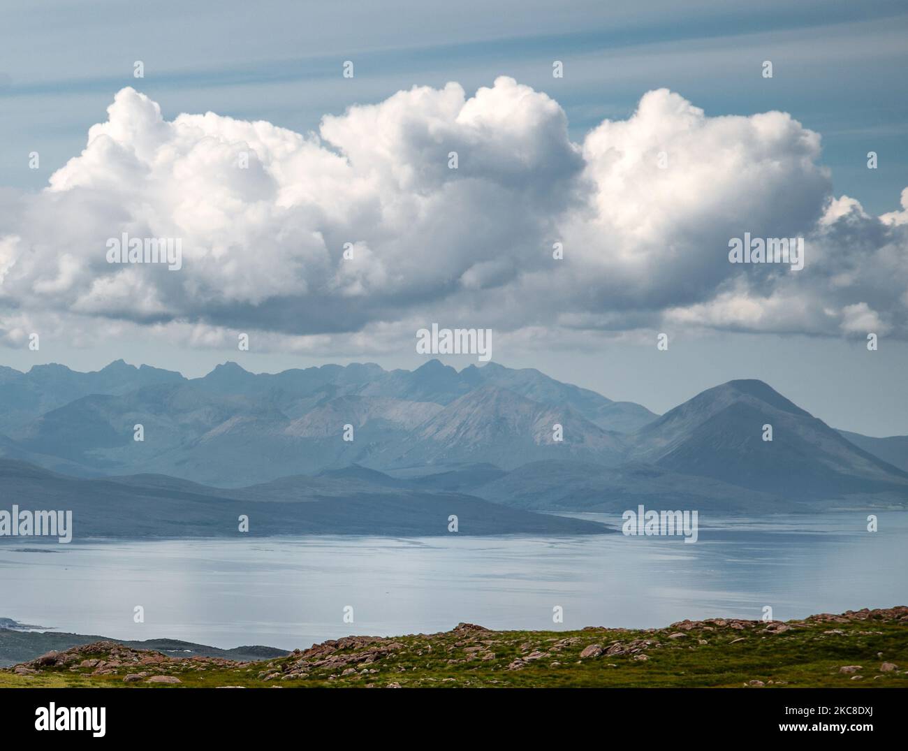 Across the calm sea to Skye', summer sky and fluffy clouds,on Applecross peninsula, in Wester Ross,Scottish Highlands.,rock strewn stunning landscape, Stock Photo