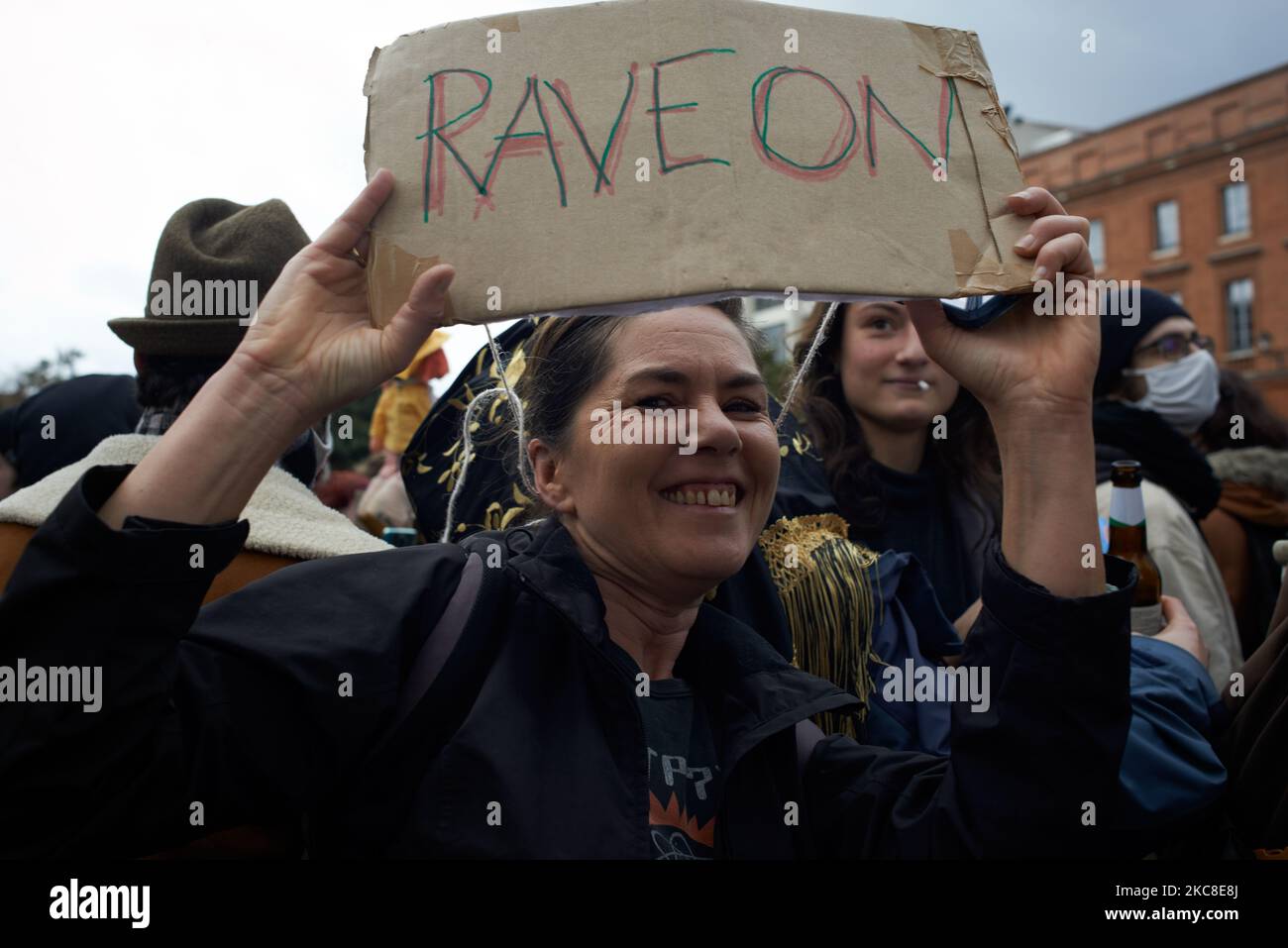 Reading Rave A woman holds placard reading 'Raveons'. It's pun on 'Rave on' and 'Let ...