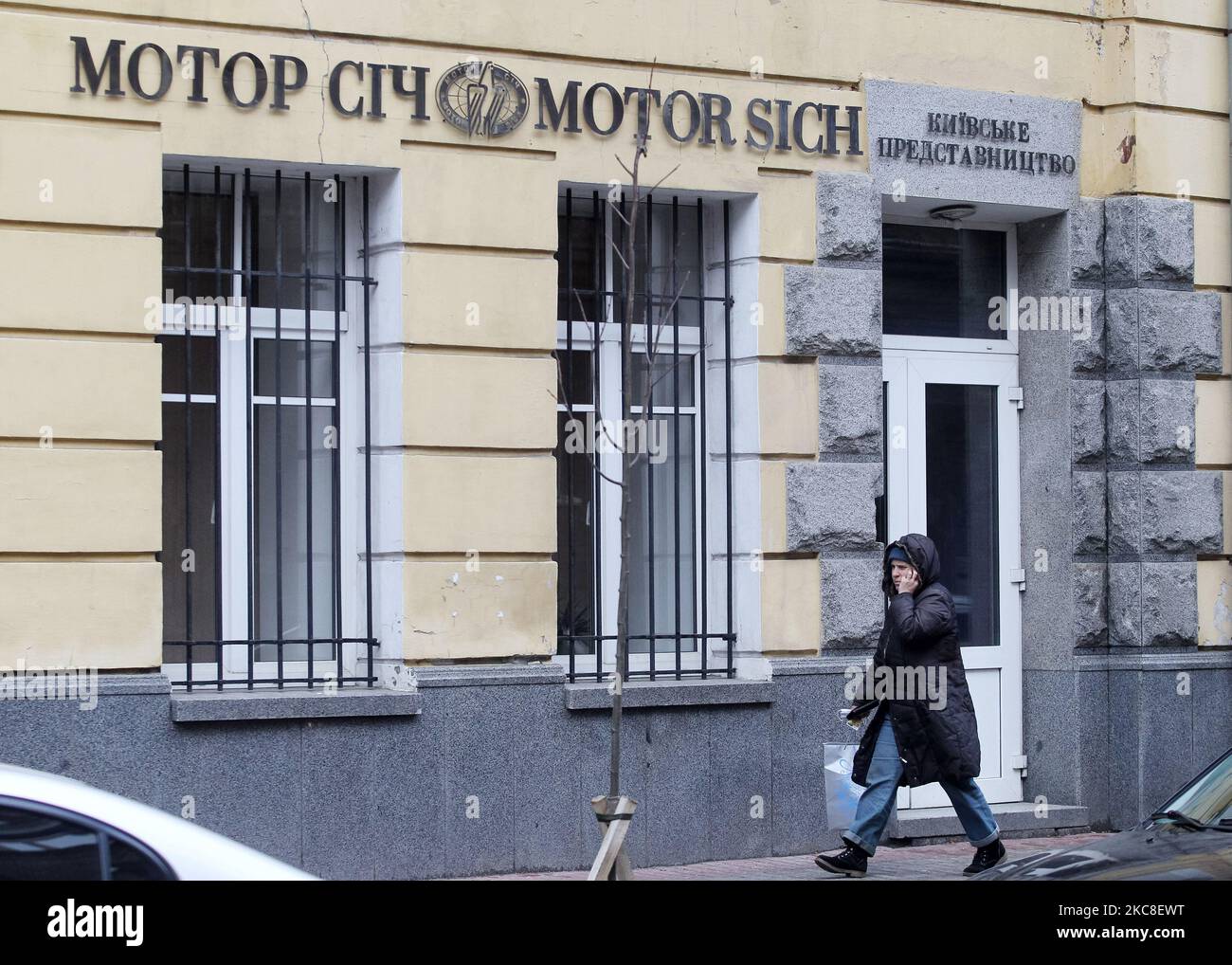 A woman walks past Motor Sich Kyiv office in the center of Kyiv