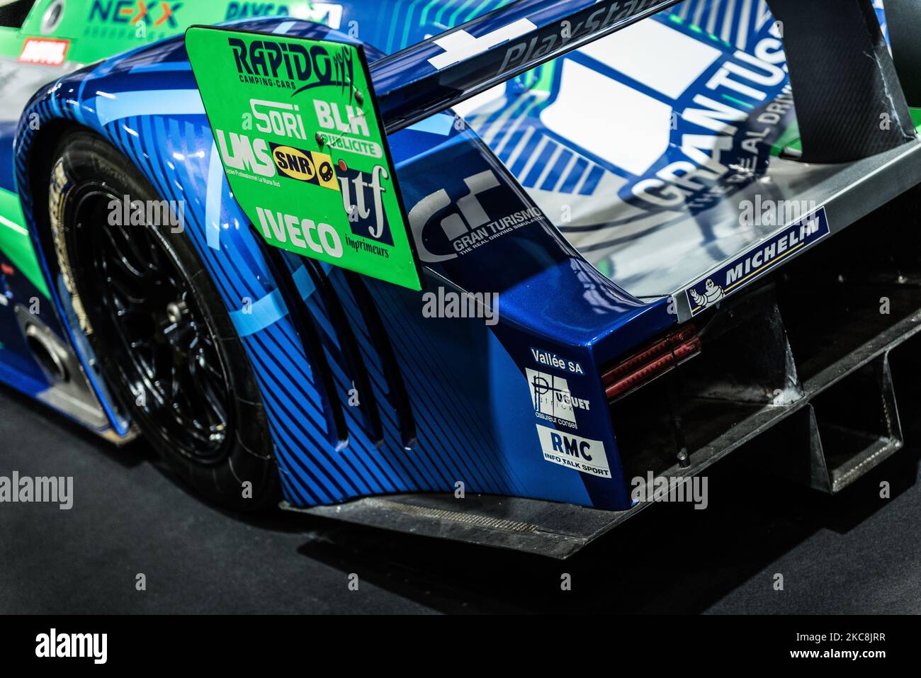 A closeup of a rear three-quarters of blue and green racecar Stock Photo