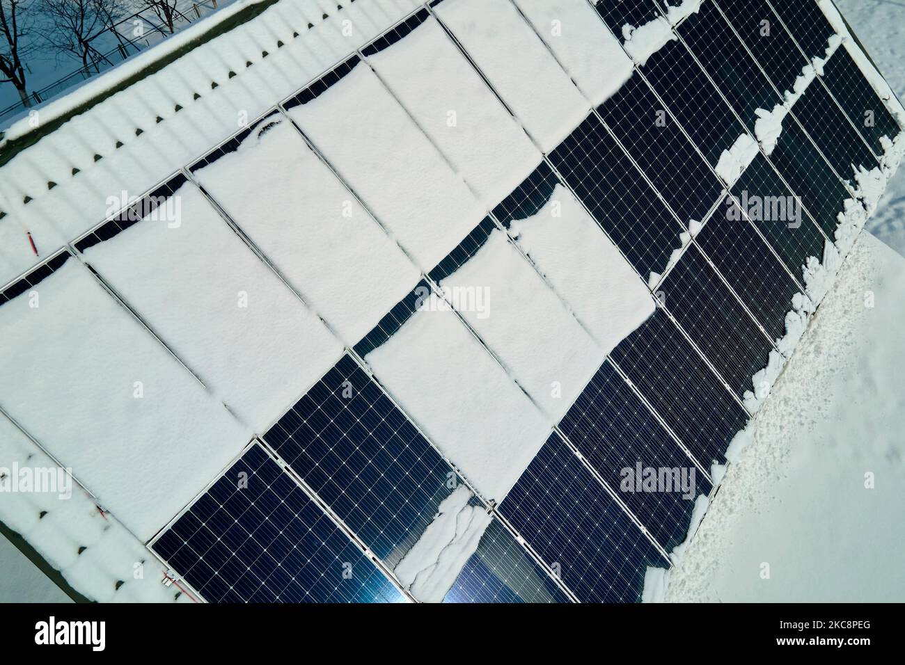 Aerial view of snow melting from covered solar photovoltaic panels