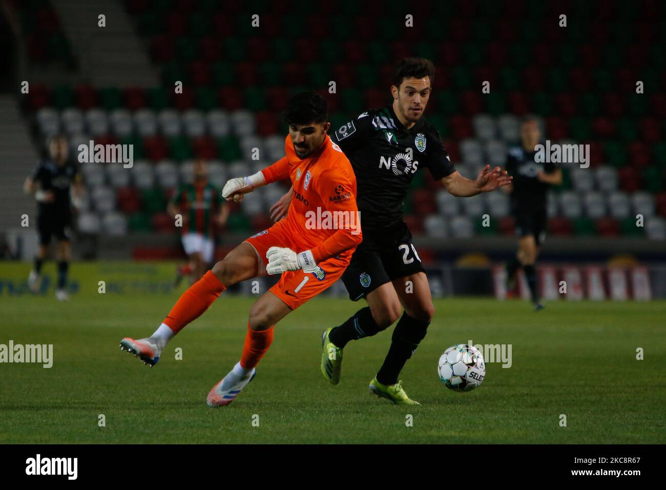 Pedro Gonçalves midfielder of Sporting CP battle for the ball with Amir goalkeeper of CS Maritimo during the Liga Nos match between CS Maritimo and Sporting SP at Estádio do Maritimo on February 05, 2021 in Funchal, Madeira, Portugal. (Photo by Valter Gouveia/NurPhoto) Stock Photo