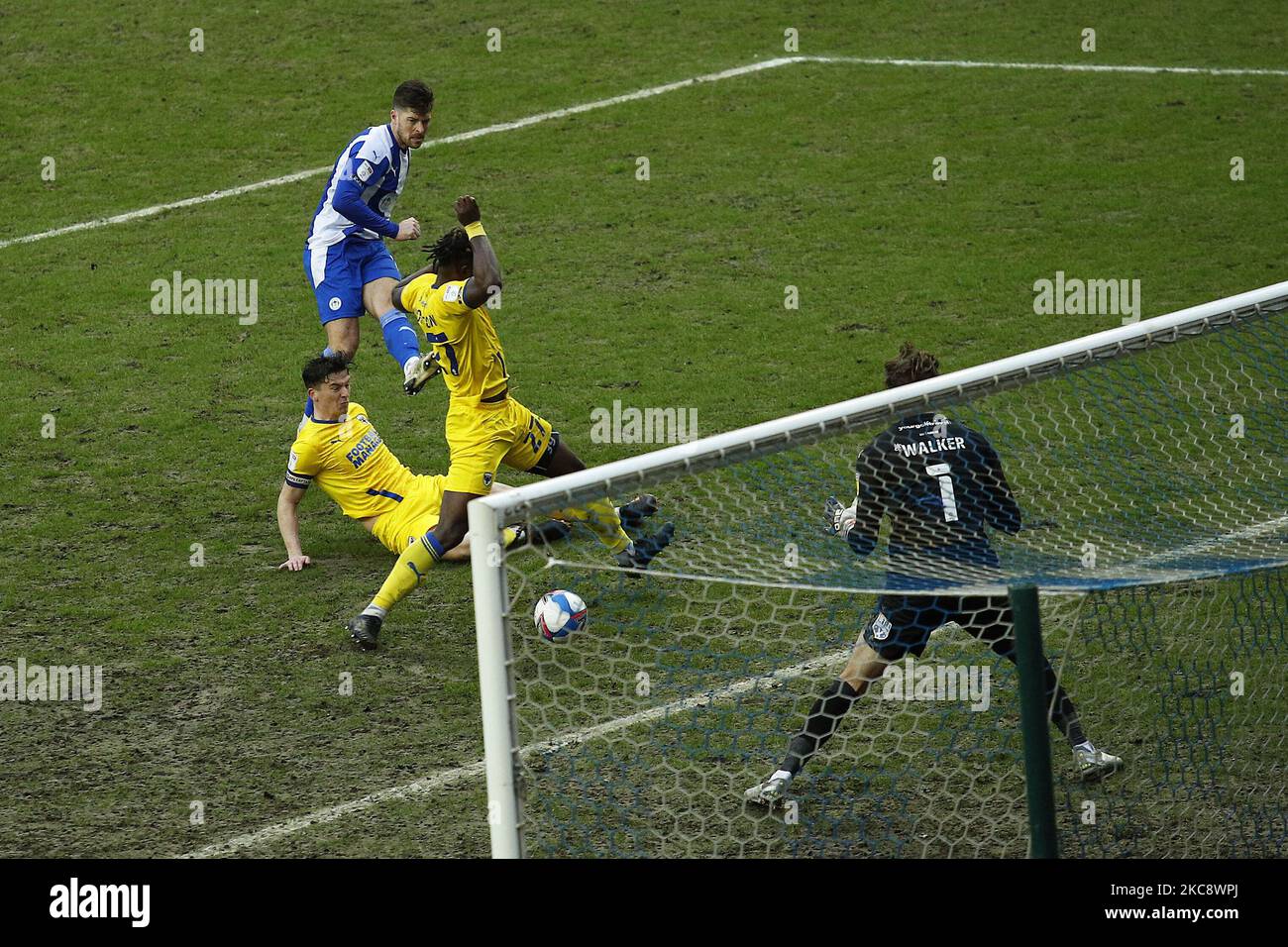 Wigans Jamie Proctor shoots and scores to make it 2-2 during the Sky Bet League 1 match between Wigan Athletic and AFC Wimbledon at the DW Stadium, Wigan on Saturday 6th February 2021. (Photo by Chris Donnelly/MI News/NurPhoto) Stock Photo