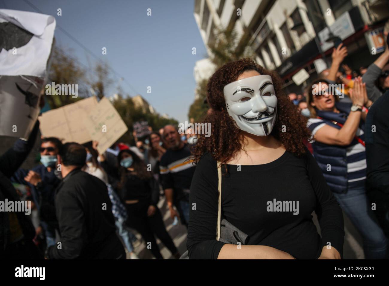 A Tunisian female protester wearing anonymous mask, during a march held towards avenue Habib Bourguiba in the capital Tunis in commemoration of the 8th anniversary of the assassination of the leftist opposition politician Chokri Belaid to call for uncovering the truth about the assassination of Chokri Belaid. Demonstrators also protested against police repression and demanded the release of young people arrested by the security forces. Some young protesters called for the decriminalization of Cannabis and soft drugs, and some others called for the fall of the government of the Prime Minister H Stock Photo