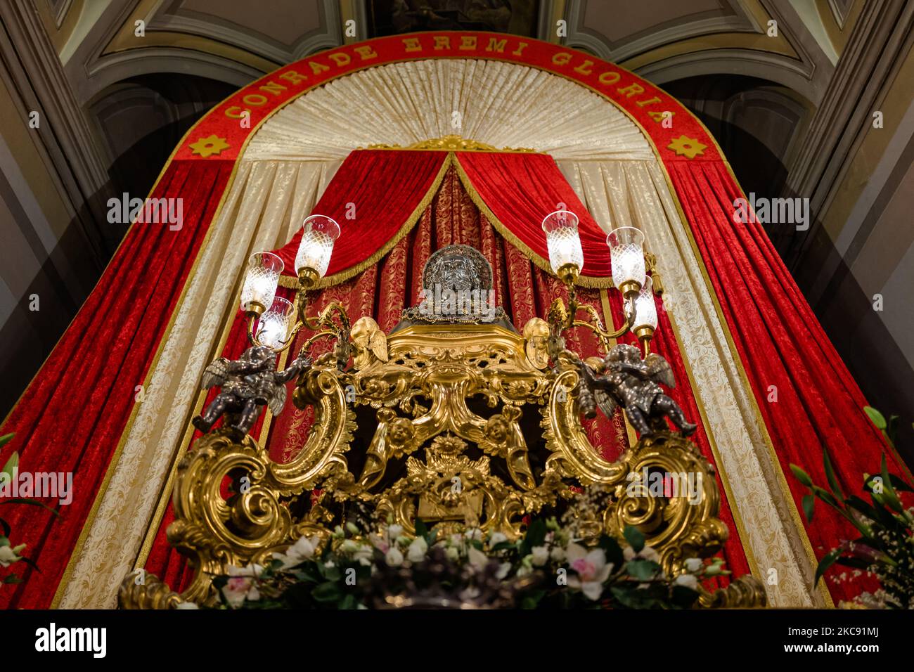 The statue of San Corrado exhibited in the Cathedral of Molfetta on February 9, 2021 in Molfetta. February 9 is the liturgical feast dedicated to San Corrado, patron saint of Molfetta. On this date the Church remembers the day on which, according to tradition, the relics of the Saint were transferred from Modugno, the place of his death, to Molfetta. The feast of San Corrado this year, for obvious reasons related to the current health emergency, was devoid of celebrations that had seen the city community gather around the traditional lighting of bonfires but only religious with various celebra Stock Photo