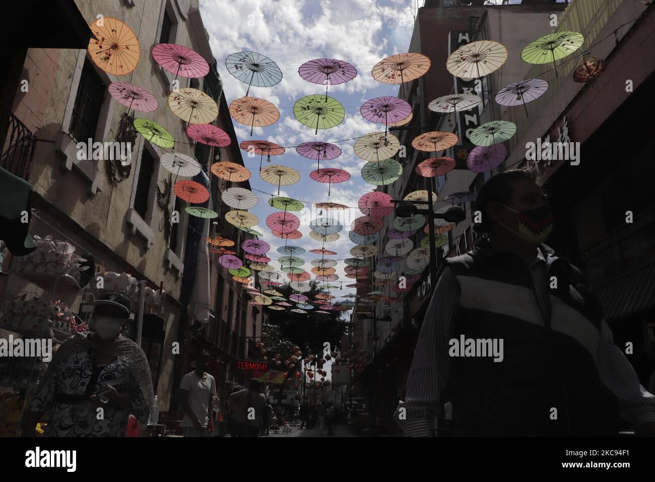 Colored umbrellas hang over cables in Mexico City's Chinatown, as part