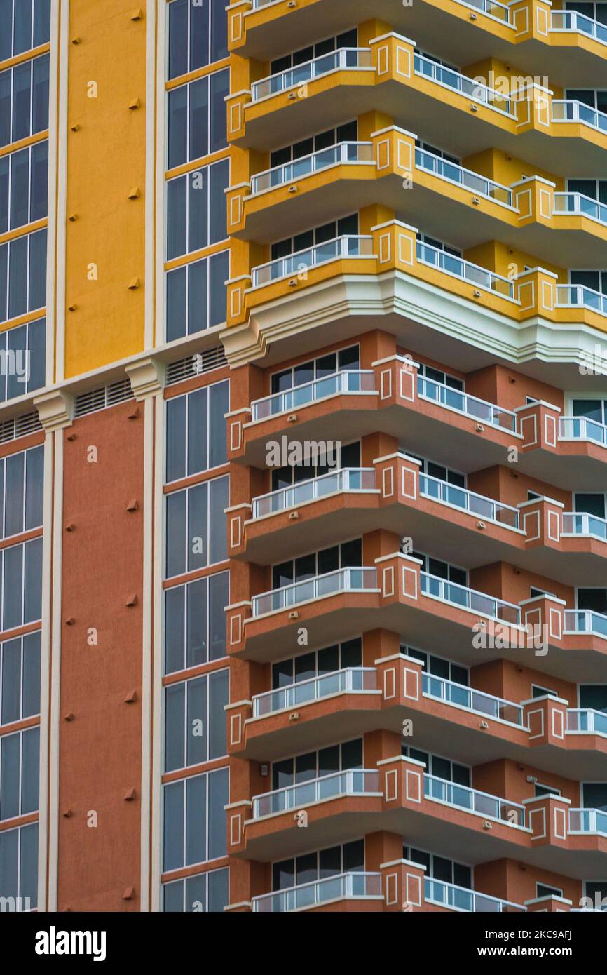 An orange and yellow building facade with balconies Stock Photo - Alamy