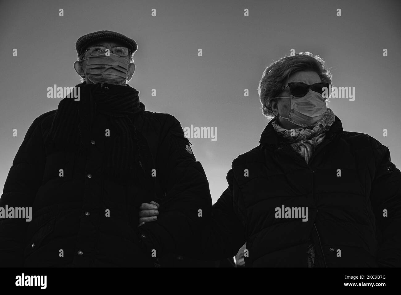 (EDITOR'S NOTE: Image was converted to black and white) In the picture an elderly couple in line, wearing protective masks, at the entrance of the Padova Fiera pavilion waiting to be able to enter and receive the first dose of the vaccine against Covid19 (Coronavirus) produced by Pfizer-BioNtech. The municipality of Padua has set up a point for vaccination against Covid19 (Coronavirus) with the vaccine produced by Pfizer-BioNTech inside the pavilions of the exhibition complex in Via Tommaseo. The vaccination campaign for the elderly Over 80 starts today. On February 15, 2021, in Padua, Italy ( Stock Photo