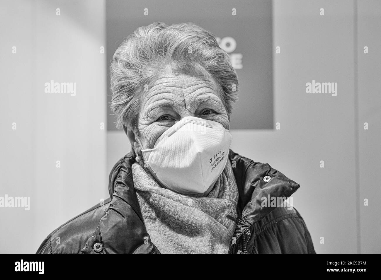 (EDITOR'S NOTE: Image was converted to black and white) In the picture Mrs. Luciana Esti is the first elderly woman over 80 from Padua to receive the first dose of the vaccine against Covid19 produced by Pfizer-Biontech. Wear a protective mask. The municipality of Padua has set up a point for vaccination against Covid19 (Coronavirus) with the vaccine produced by Pfizer-BioNTech inside the pavilions of the exhibition complex in Via Tommaseo. The vaccination campaign for the elderly Over 80 starts today. On February 15, 2021, in Padua, Italy (Photo by Roberto Silvino/NurPhoto) Stock Photo