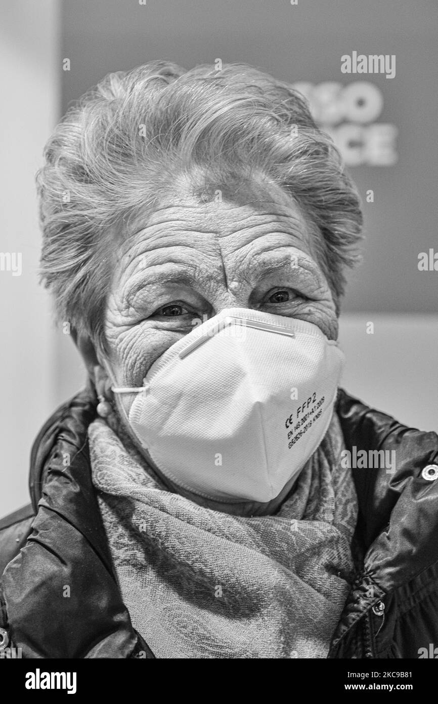 (EDITOR'S NOTE: Image was converted to black and white) In the picture Mrs. Luciana Esti is the first elderly woman over 80 from Padua to receive the first dose of the vaccine against Covid19 produced by Pfizer-Biontech. Wear a protective mask. The municipality of Padua has set up a point for vaccination against Covid19 (Coronavirus) with the vaccine produced by Pfizer-BioNTech inside the pavilions of the exhibition complex in Via Tommaseo. The vaccination campaign for the elderly Over 80 starts today. On February 15, 2021, in Padua, Italy (Photo by Roberto Silvino/NurPhoto) Stock Photo