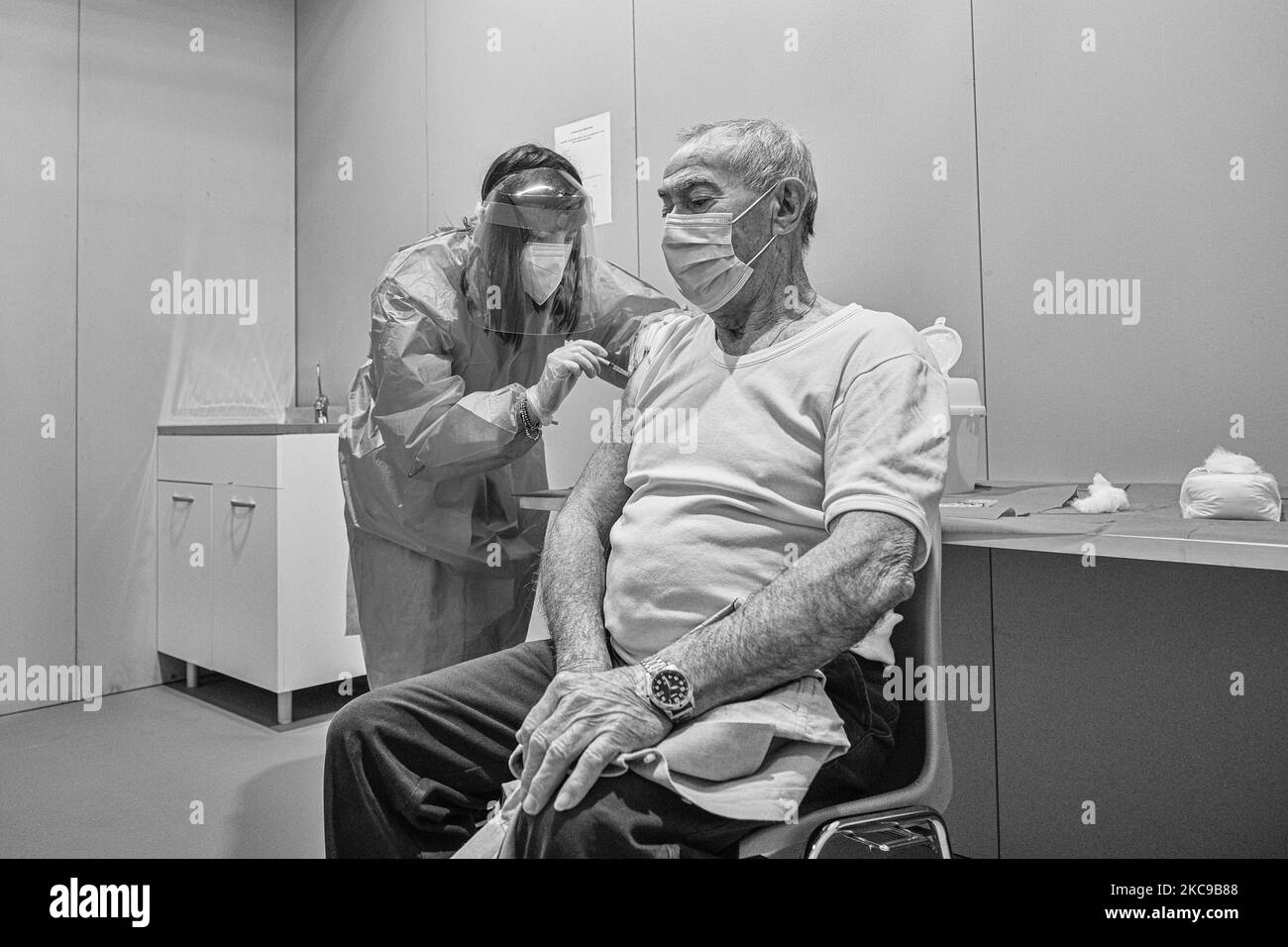 (EDITOR'S NOTE: Image was converted to black and white) In the picture a moment of the vaccination of Mr. Antonio Gallo, the third elderly over 80 to receive the first dose of the Pfizer-BioNTech vaccine against Covid19 (Coronavirus) in Padua The municipality of Padua has set up a point for vaccination against Covid19 (Coronavirus) with the vaccine produced by Pfizer-BioNTech inside the pavilions of the exhibition complex in Via Tommaseo. The vaccination campaign for the elderly Over 80 starts today. On February 15, 2021, in Padua, Italy (Photo by Roberto Silvino/NurPhoto) Stock Photo