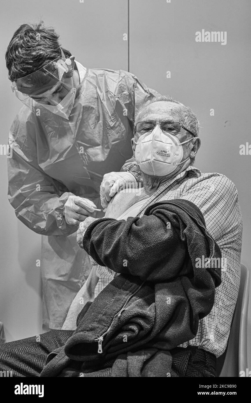 (EDITOR'S NOTE: Image was converted to black and white) In the picture a moment of vaccination against Covid19 with the vaccine produced by Pfizer-BioNTech of an elderly over 80 at the Padua Fair used as a clinic for the occasion. The municipality of Padua has set up a point for vaccination against Covid19 (Coronavirus) with the vaccine produced by Pfizer-BioNTech inside the pavilions of the exhibition complex in Via Tommaseo. The vaccination campaign for the elderly Over 80 starts today. On February 15, 2021, in Padua, Italy (Photo by Roberto Silvino/NurPhoto) Stock Photo