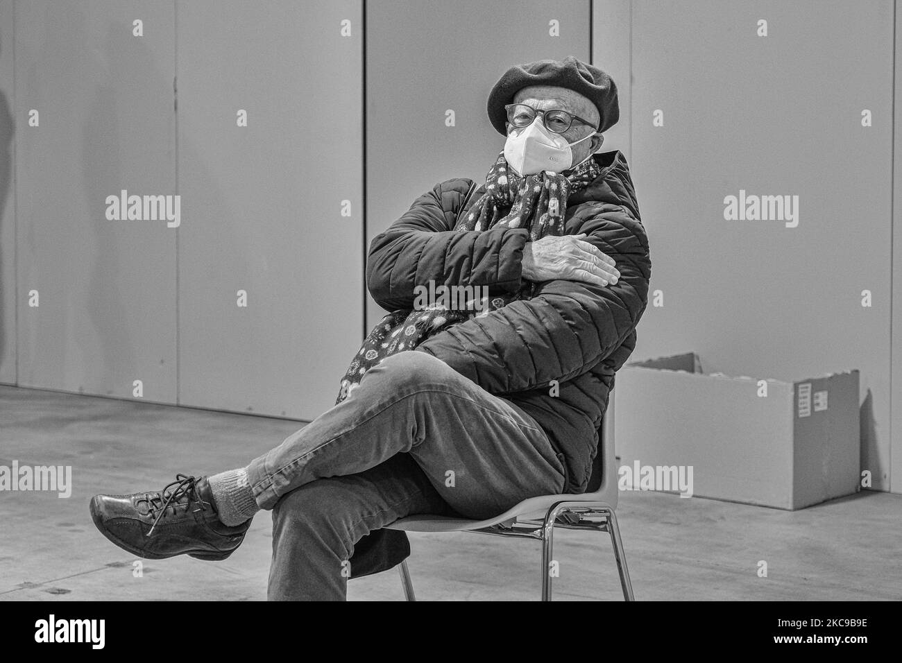 (EDITOR'S NOTE: Image was converted to black and white) In the picture an elderly man sitting in the post vaccine room holds his left arm where he was injected with the first dose of the vaccine against Covid19 produced by Pfizer-Biontech. He has to wait here for about 15 minutes before he can go home. The municipality of Padua has set up a point for vaccination against Covid19 (Coronavirus) with the vaccine produced by Pfizer-BioNTech inside the pavilions of the exhibition complex in Via Tommaseo. The vaccination campaign for the elderly Over 80 starts today. On February 15, 2021, in Padua, I Stock Photo