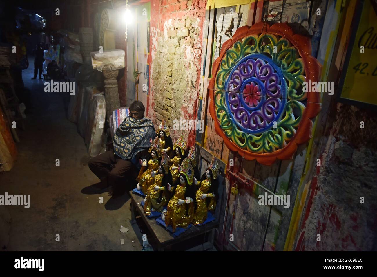 A man waits for his customer as he sells Saraswati goddess in Kolkata, India, 15 February, 2021. Basant Panchami, which will be celebrated on 16 February this year, marks the advent of spring. (Photo by Indranil Aditya/NurPhoto) Stock Photo