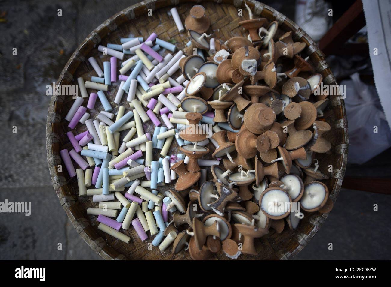 A street vendor selling writing chalks and butter lamps during Basant