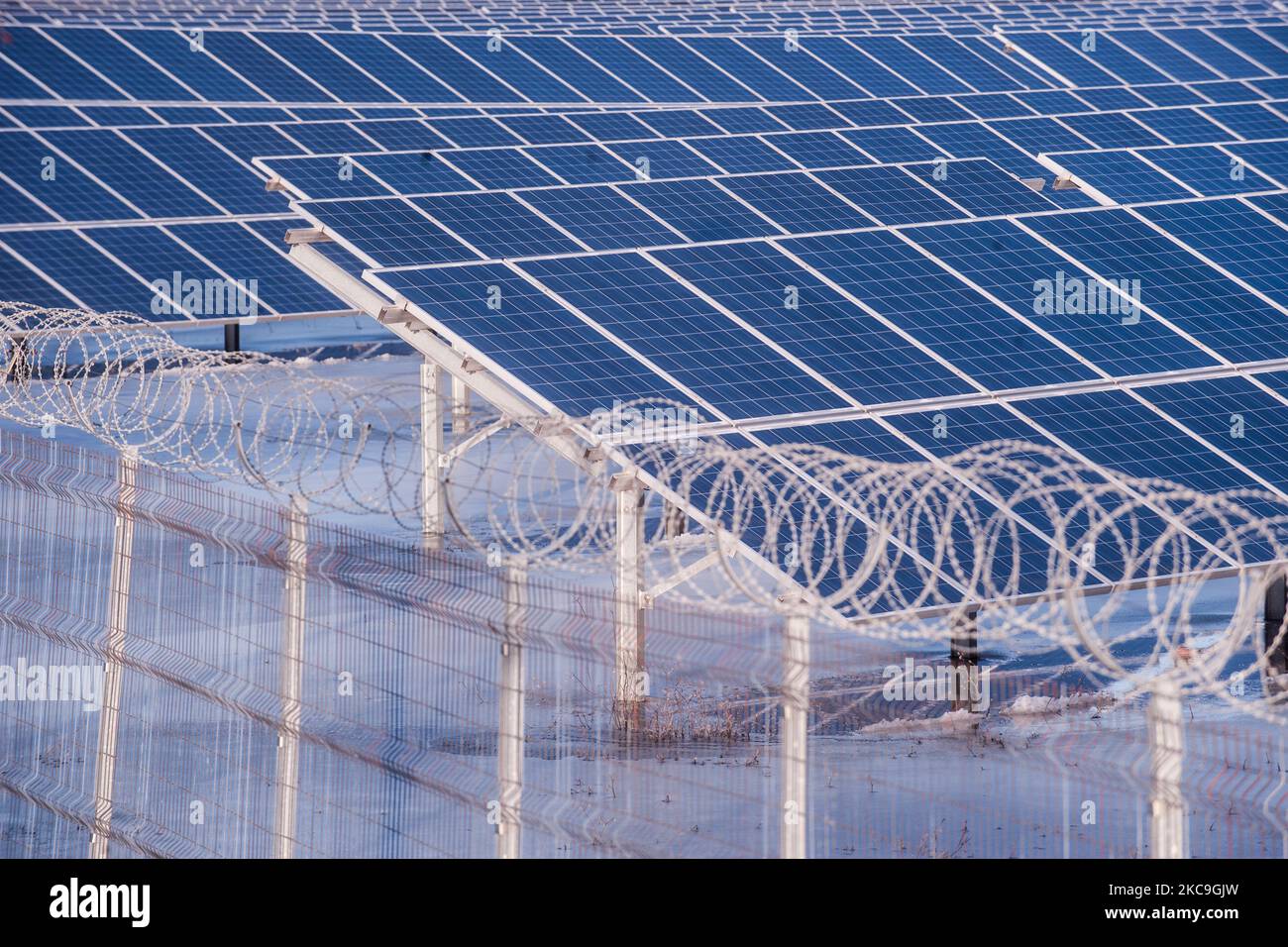 Solar panels from a photovoltaic power station seen through barbed wire on February 17th 2021 near Krumovo, Bulgaria. (Photo by Denislav Stoychev/NurPhoto) Stock Photo