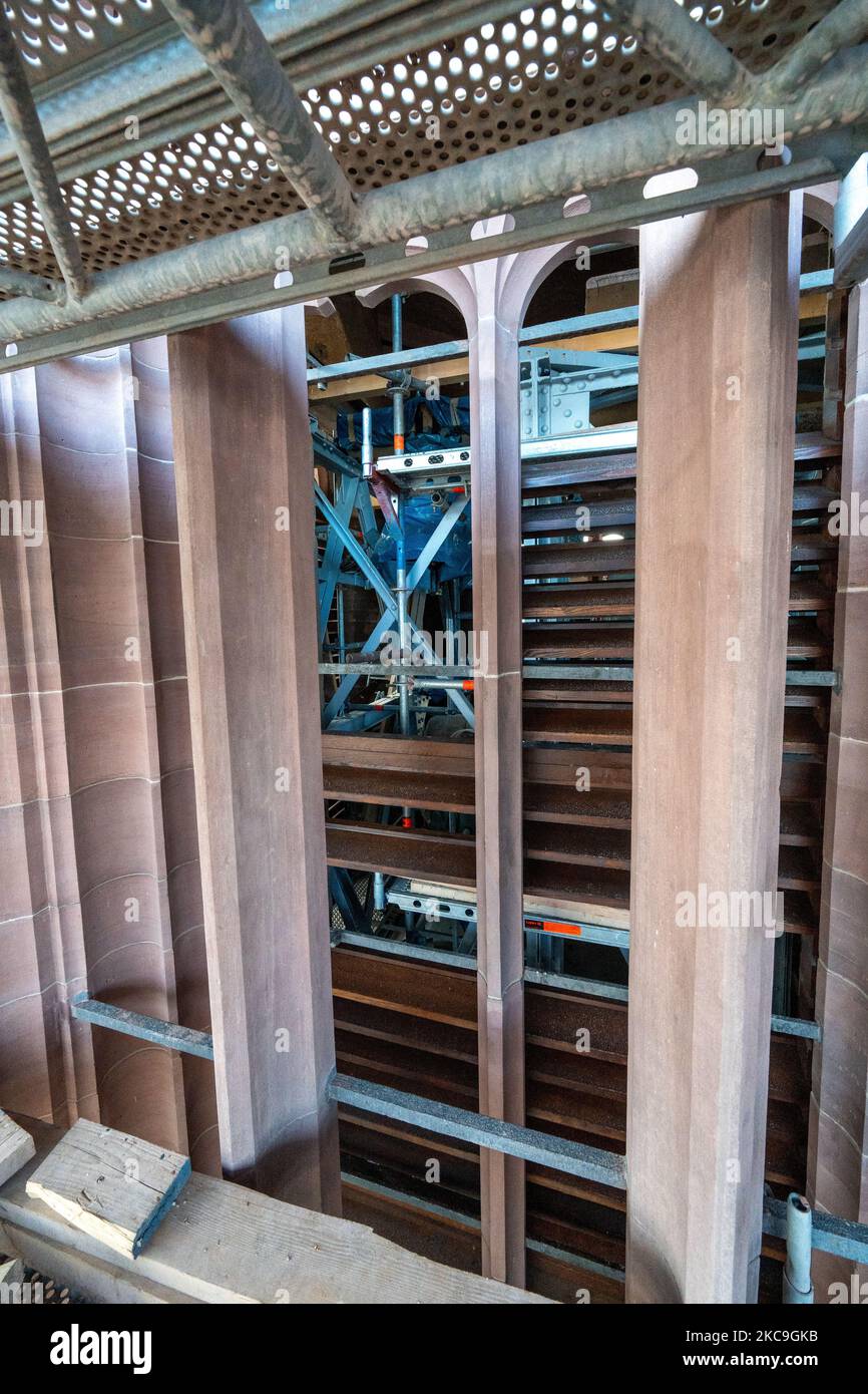 A vertical shot of a construction site with scaffolding against brick ...