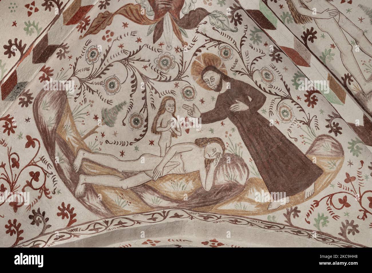 Creation of Eve from one of Adam´s ribs, an ancient fresco in Fanefjord church, Denmark, October 10, 2022 Stock Photo