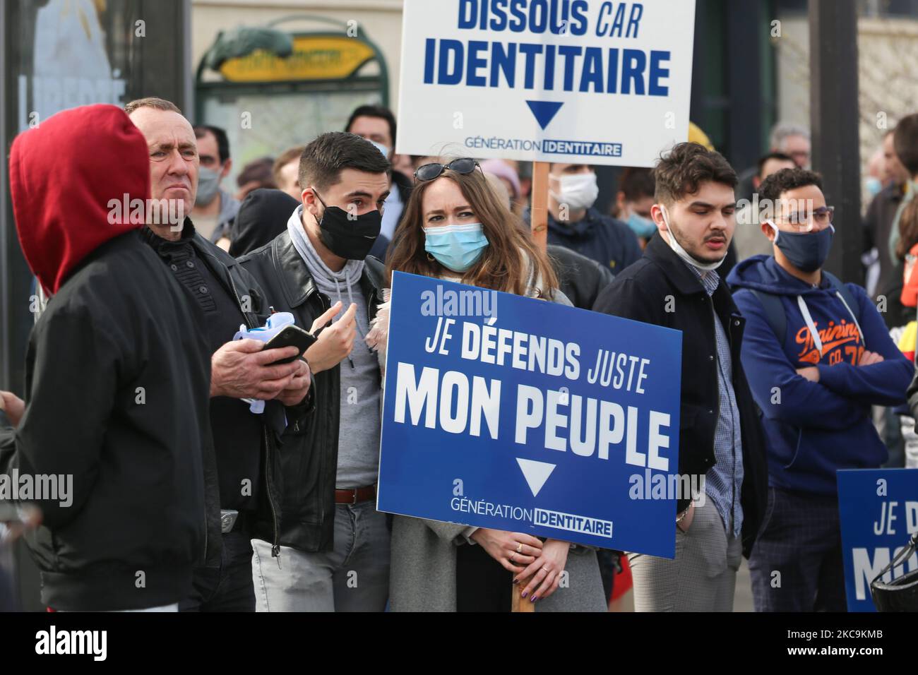 A member of far right group Generation Identitaire (GI) holds a placard reading « I’m just defending my people » during a protest against its potential dissolution in Place Denfert Rochereau, in Paris on February 20, 2021. The dissolution of Generation identitaire was evoked for the first time on January 26, 2021 by Interior Minister, as a reaction to the group's recent anti-migrant operation in the Pyrenees, which led to a preliminary investigation for provocation to racial hatred. (Photo by Michel Stoupak/NurPhoto) Stock Photo