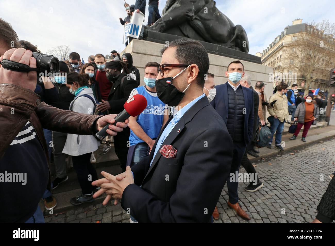 Member of far-right Rassemblement National's (RN) Jean Messiha (C) speaks with the press during a protest against the far right Generation Identitaire group's potential dissolution in Place Denfert Rochereau, in Paris on February 20, 2021. The dissolution of Generation identitaire was evoked for the first time on January 26, 2021 by Interior Minister, as a reaction to the group's recent anti-migrant operation in the Pyrenees, which led to a preliminary investigation for provocation to racial hatred. (Photo by Michel Stoupak/NurPhoto) Stock Photo