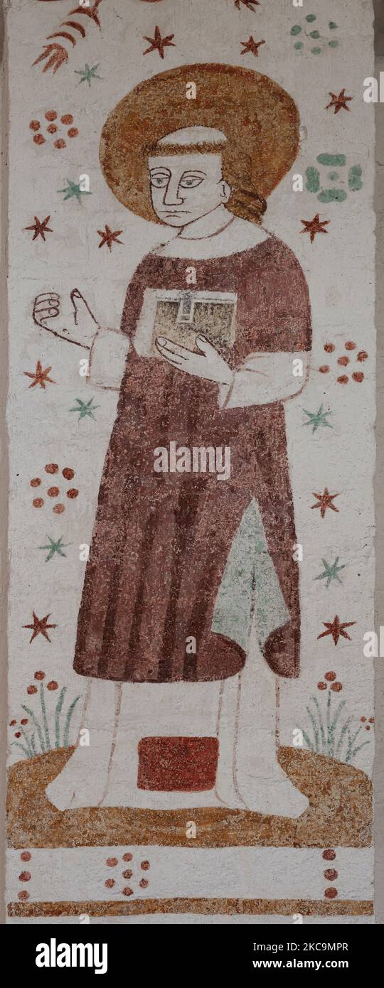 500 years old mural depicting a monk in a cloak and with tonsure on a pillar in Fanefjord church, Denmark, October 10, 2022 Stock Photo