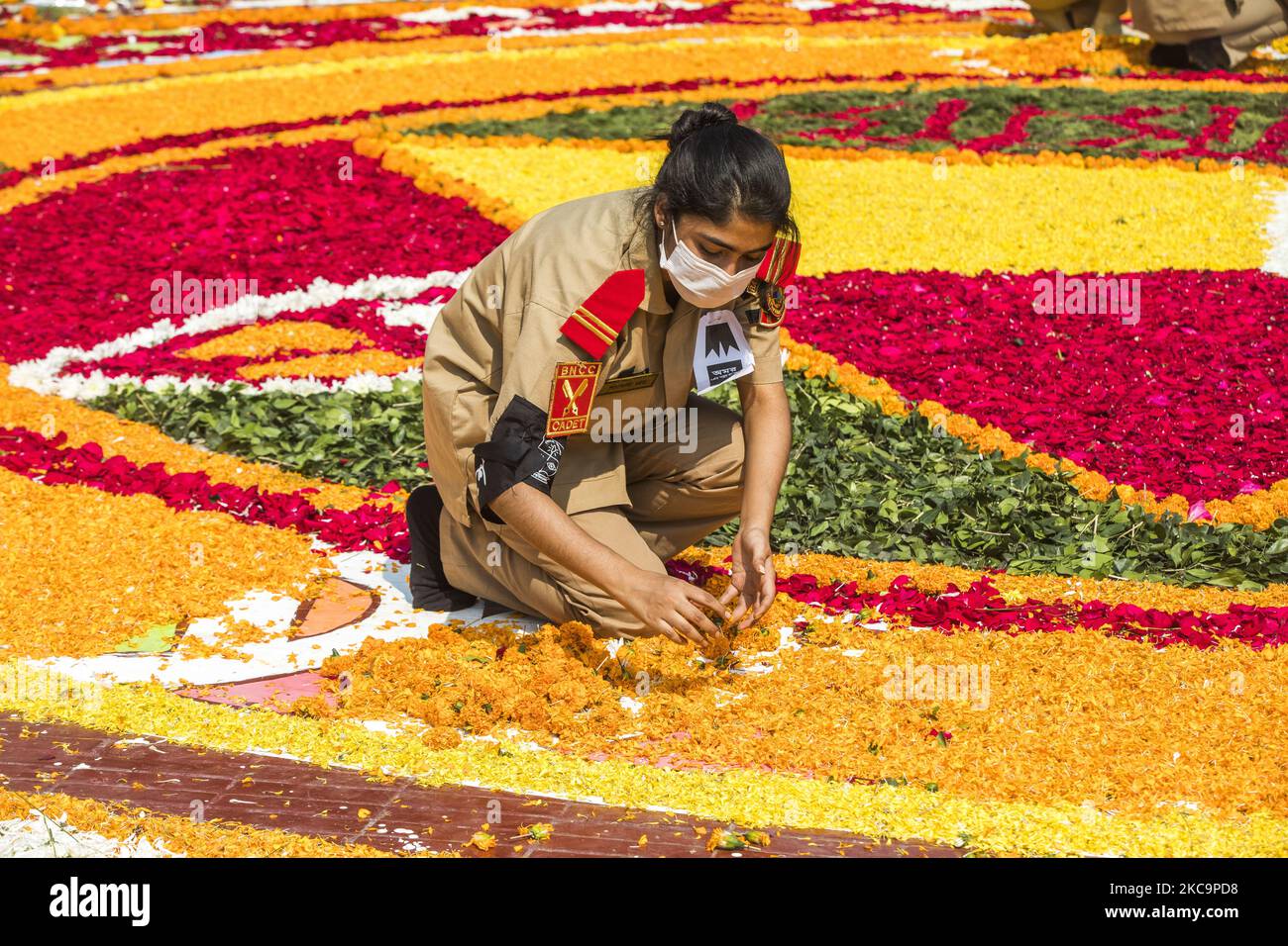 Youth decorate with flowers the Bangladesh Central Language Martyrs' Memorial monument in homage to the martyrs of the 1952 Bengali language movement during the International Mother Language Day, in Dhaka on February 21, 2021. This event is dedicated to the martyrs who died on 21 February 1952 in a demonstration calling for the establishment of Bengali as one of the state languages of former East Pakistan. (Photo by Ahmed Salahuddin/NurPhoto) Stock Photo