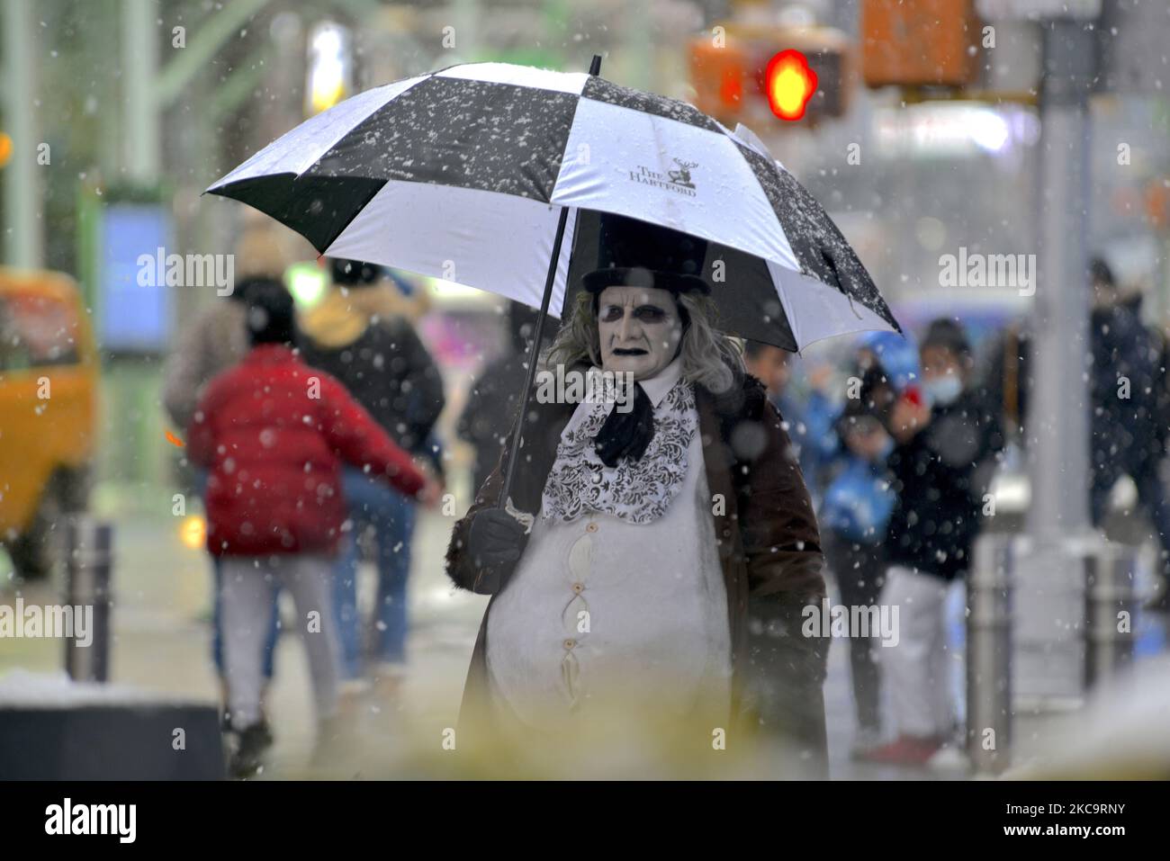A street performer is dressed as 'The Penguin' from Batman at Times Square during a snowfall on February 19, 2021 in New York City. (Photo by Deccio Serrano/NurPhoto) Stock Photo