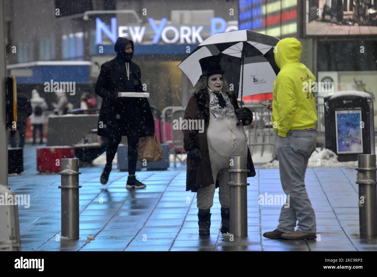 A street performer is dressed as 'The Penguin' from Batman at Times Square during a snowfall on February 19, 2021 in New York City. (Photo by Deccio Serrano/NurPhoto) Stock Photo