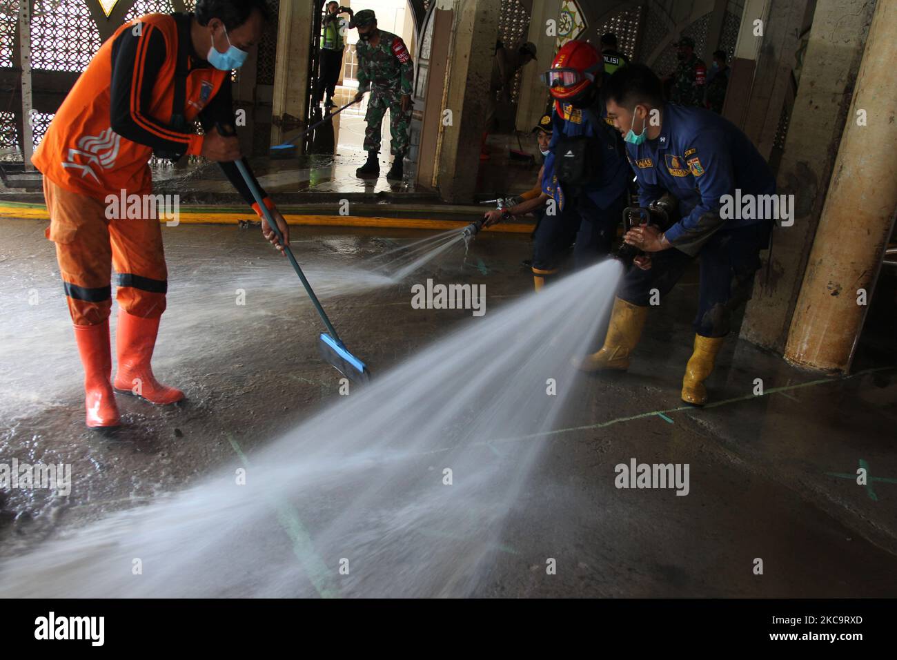 Officers clean up a house of worship (Mosque) in a residential area hit by two meter flood in Cipinang Melayu, Jakarta, on February 22,2021. (Photo by Dasril Roszandi/NurPhoto) Stock Photo