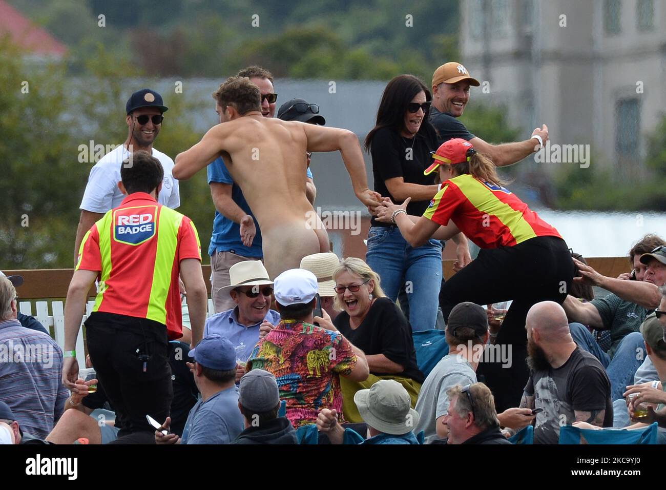 Members of the ground security try to catch a streaker during the second Twenty20 international cricket match between New Zealand and Australia at University Oval in Dunedin, New Zealand on February 25, 2021. (Photo by Sanka Vidanagama/NurPhoto) Stock Photo