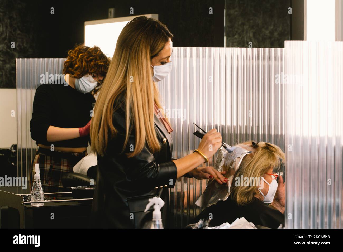 hairdressers dye their clients' in Cologne, Germany, on March 1, 2021