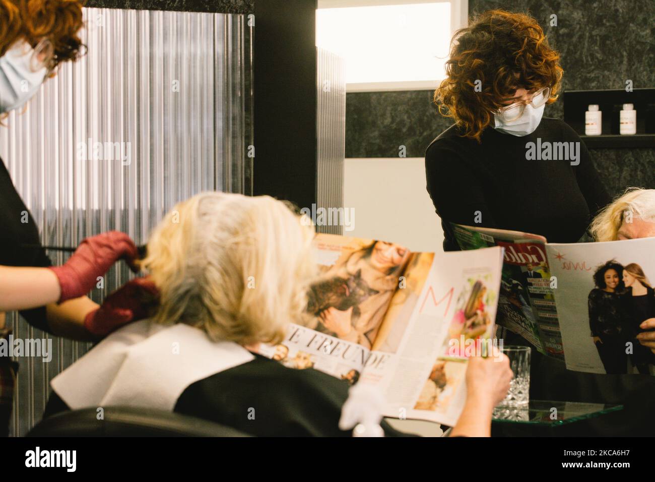 a hairdresser dyes her clients' in Cologne, Germany, on March 1, 2021