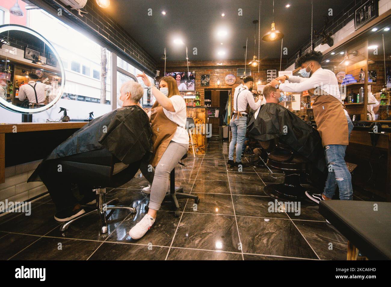 Hairdressers Cut The Hair Of A Client In Salon Anis In Cologne Germany