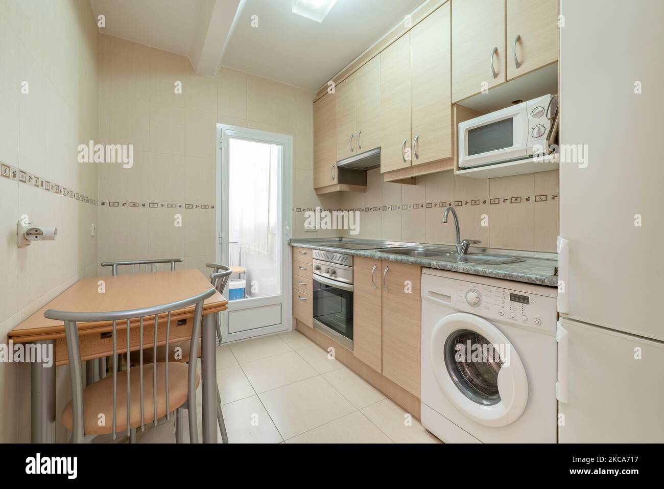 Kitchen with beechtoned wood paired with white appliances and