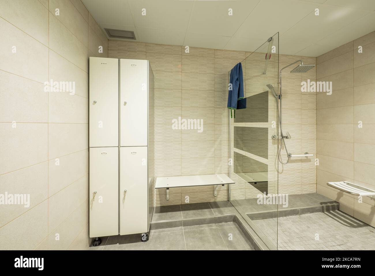 Toilet of a gym with shower cabin with glass partition and lockers with individual lock Stock Photo