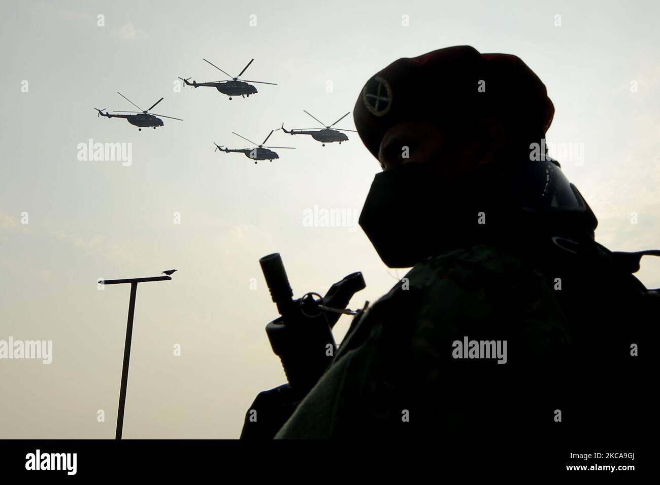 A Sri Lankan Soldier Stand Guard As The Indian Air Force Helicopter a-sri-lankan-soldier-stand-guard-as-the-indian-air-force-helicopter