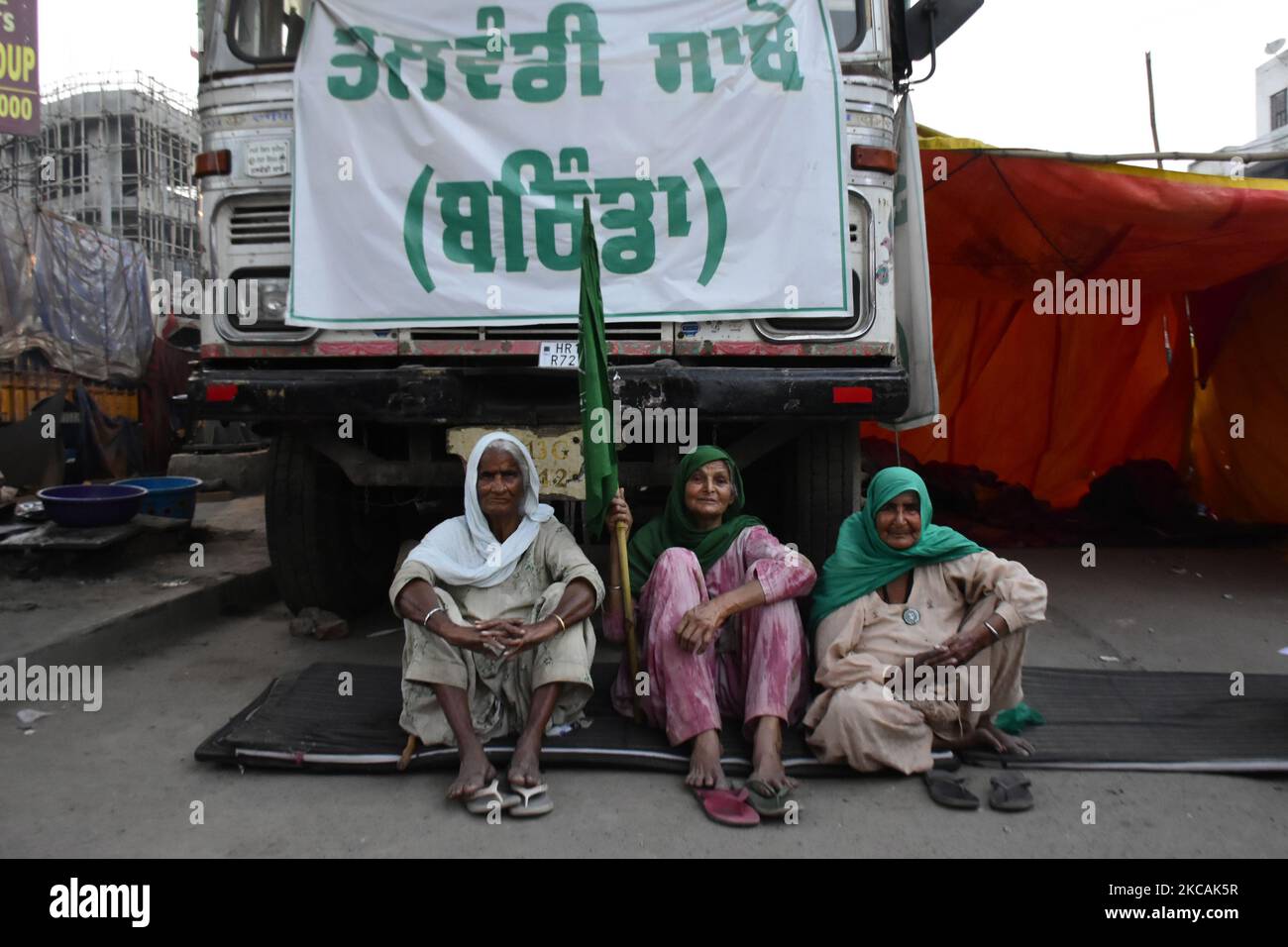 Indian Women farmers sit near a vehicle at tikri border (Delhi-Haryana Border) on 08 February 2021. Thousands of women also gathered at all the protest sites on International womens day protesting against the three farm bills passed by centrral government. (Photo by Muzamil Mattoo/NurPhoto) Stock Photo
