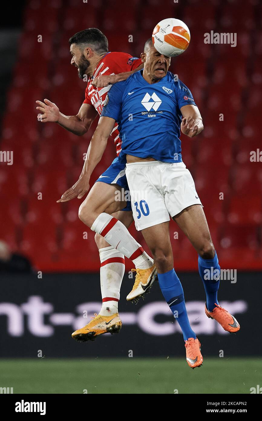 Mathis Bolly of Molde and Jorge Molina of Granada compete for the ball during the UEFA Europa League Round of 16 First Leg match between Granada and Molde at Estadio Nuevo Los Carmenes on March 11, 2021 in Granada, Spain. Sporting stadiums around Europe remain under strict restrictions due to the Coronavirus Pandemic as Government social distancing laws prohibit fans inside venues resulting in games being played behind closed doors. (Photo by Jose Breton/Pics Action/NurPhoto) Stock Photo
