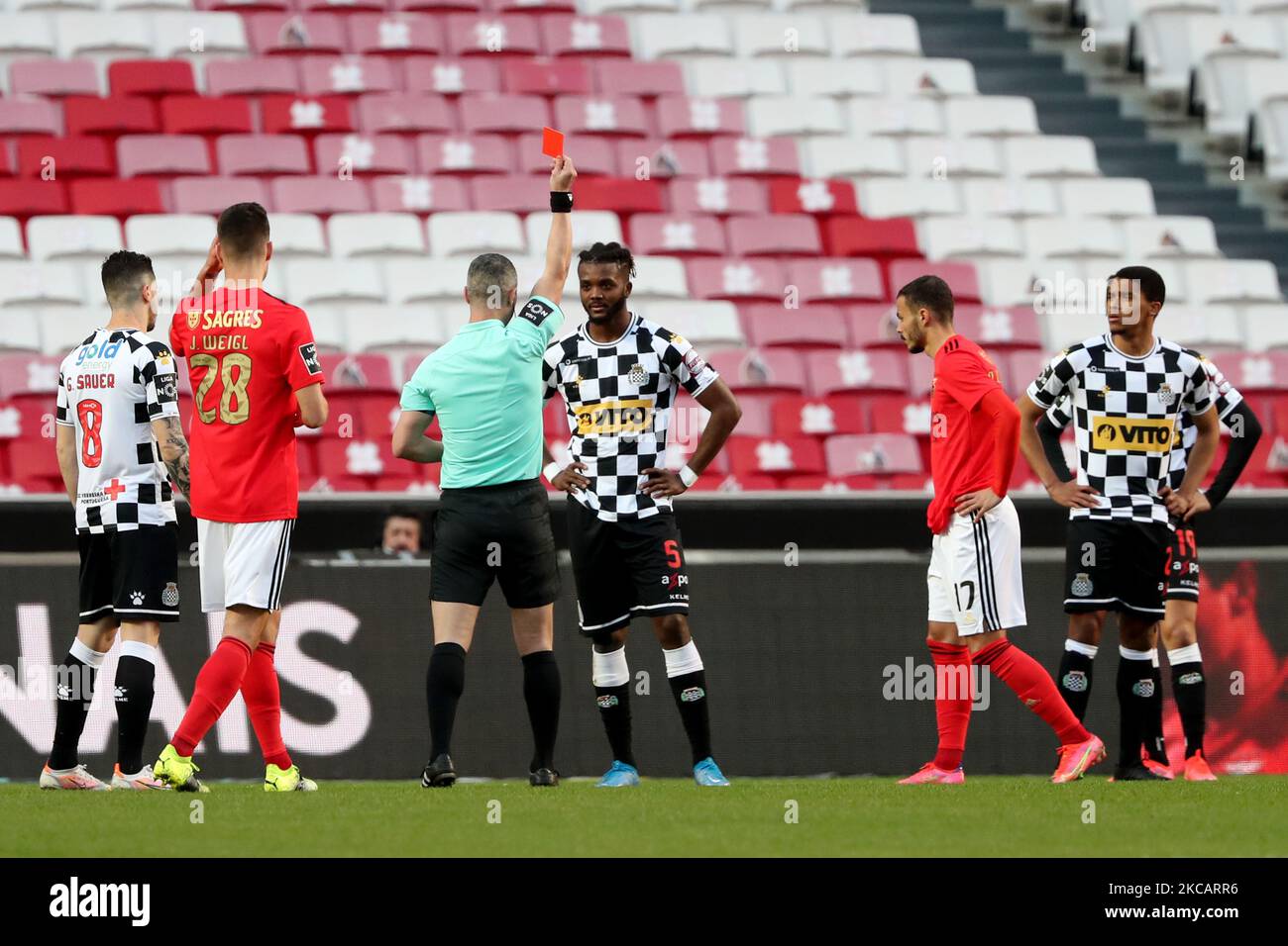 Referee Manuel Mota da Silva shows a red card to Chidozie Awaziem of Boavista FC during the Portuguese League football match between SL Benfica and Boavista FC at the Luz stadium in Lisbon, Portugal on March 13, 2021. (Photo by Pedro FiÃºza/NurPhoto) Stock Photo