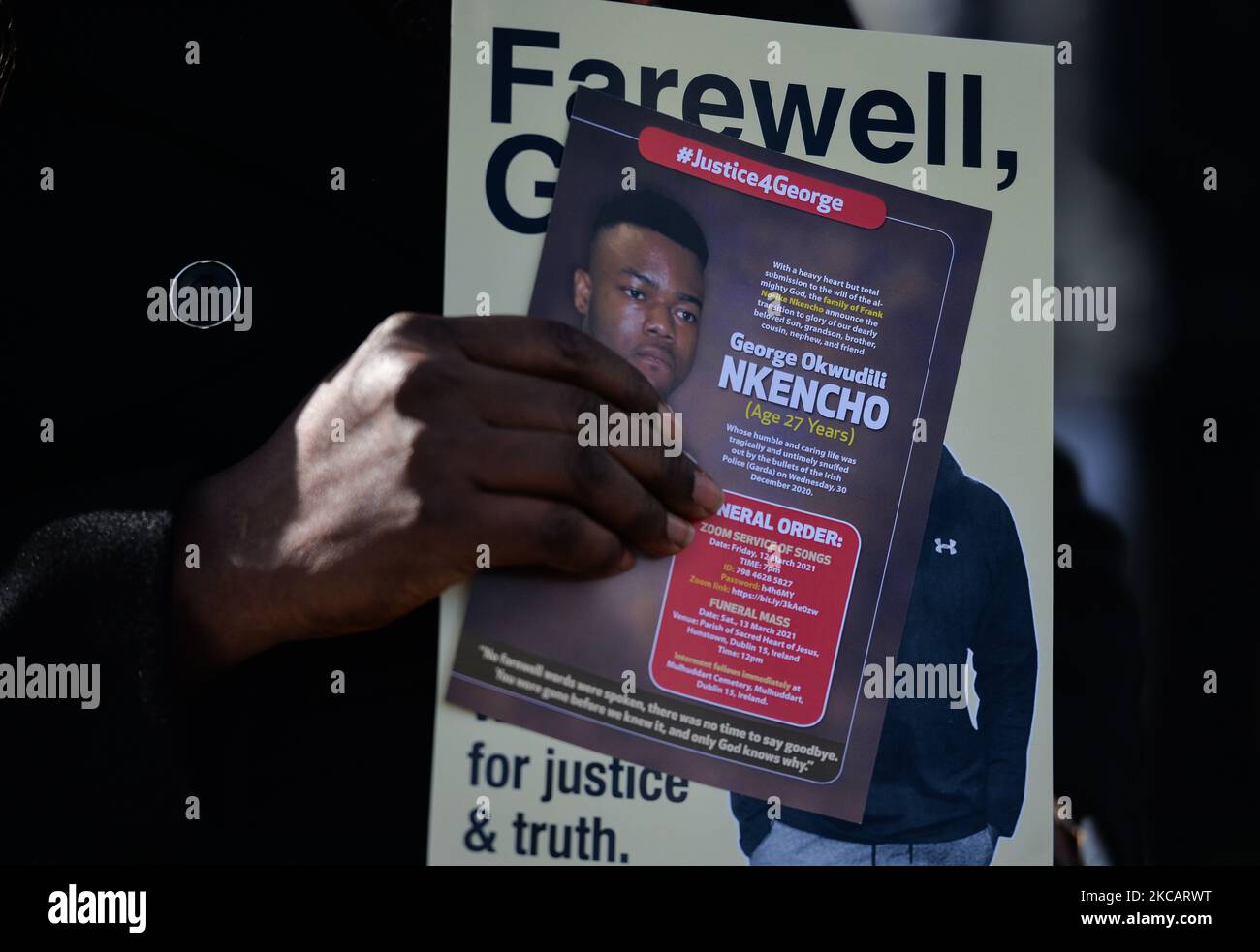 A person holds a poster with an image of George Nkencho outside the grounds of Sacred Heart of Jesus Church in Huntstown, Dublin, at the funeral of the 27-year-old man who was shot outside his home by members of the Garda Armed Support Unit last December. On Saturday, March 13, 2021, in Dublin, Ireland. (Photo by Artur Widak/NurPhoto) Stock Photo