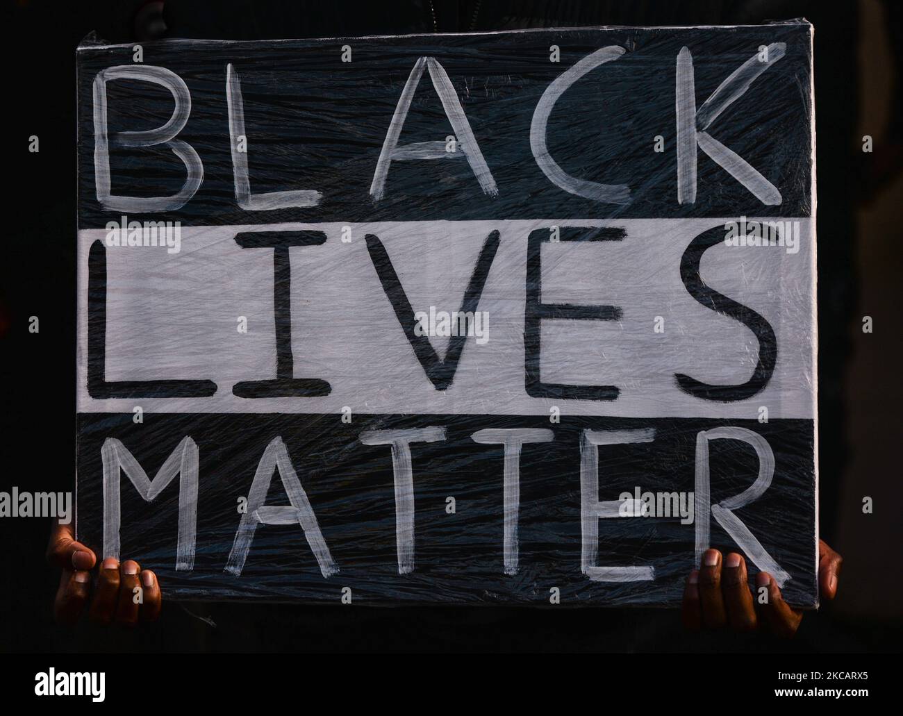 A person holds a poster that reads 'Black Lives Matter' outside the grounds of Sacred Heart of Jesus Church in Huntstown, Dublin, at the funeral of George Nkencho who was shot outside his home by members of the Garda Armed Support Unit last December. On Saturday, March 13, 2021, in Dublin, Ireland. (Photo by Artur Widak/NurPhoto) Stock Photo