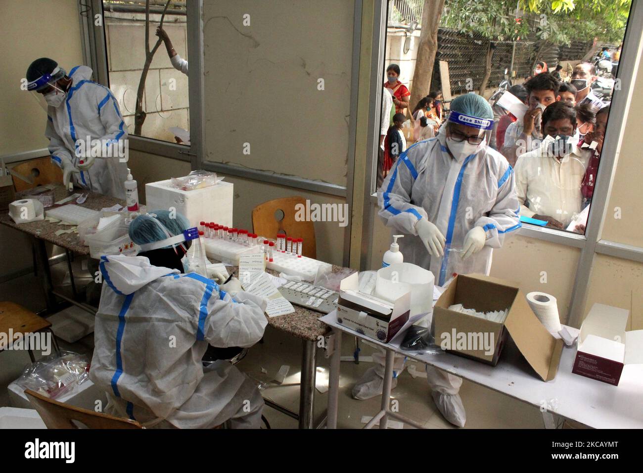 Healthcare workers wearing personal protective equipment's (PPE) collect swab samples for the coronavirus disease (COVID-19), at a testing booth setup inside the hospital in New Delhi on March 15, 2021. India reported 26,291 new cases, and 118 deaths in the last 24 hours, as per Union health ministry's updated data on Monday. (Photo by Mayank Makhija/NurPhoto) Stock Photo