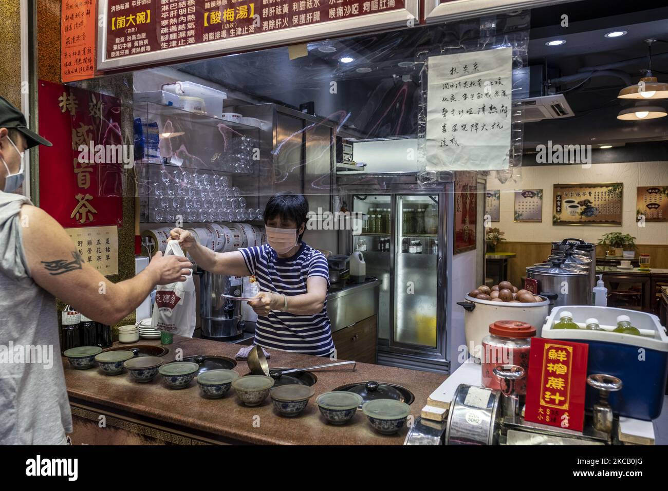 A Man buys tea at a herbal tea store in Hong Kong, Tuesday, March 16, 2021. Hong Kong's unemployment rate has risen to 7.2 Precent its highest level since 2004 amid the coronavirus outbreak, the labour minister warned that the job market still faces challenges with the pandemic not yet fully contained here, More than 261,000 people were left without a job in the period under review. That's 8,300 more than before, The city's jobless rate hit an all-time high of 8.5 percent during the Sars outbreak in 2003. (Photo by Vernon Yuen/NurPhoto) Stock Photo