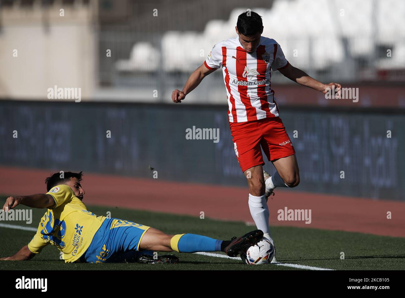 Lucas Robertone of Almeria and Fabio Gonzalez Las Palmas compete for the ball during the La Liga Smartbank match between UD Almeria and UD Las Palmas at Estadio Juegos del Mediterraneo on February 14, 2021 in Almeria, Spain. Sporting stadiums around Spain remain under strict restrictions due to the Coronavirus Pandemic as Government social distancing laws prohibit fans inside venues resulting in games being played behind closed doors. (Photo by Jose Breton/Pics Action/NurPhoto) Stock Photo