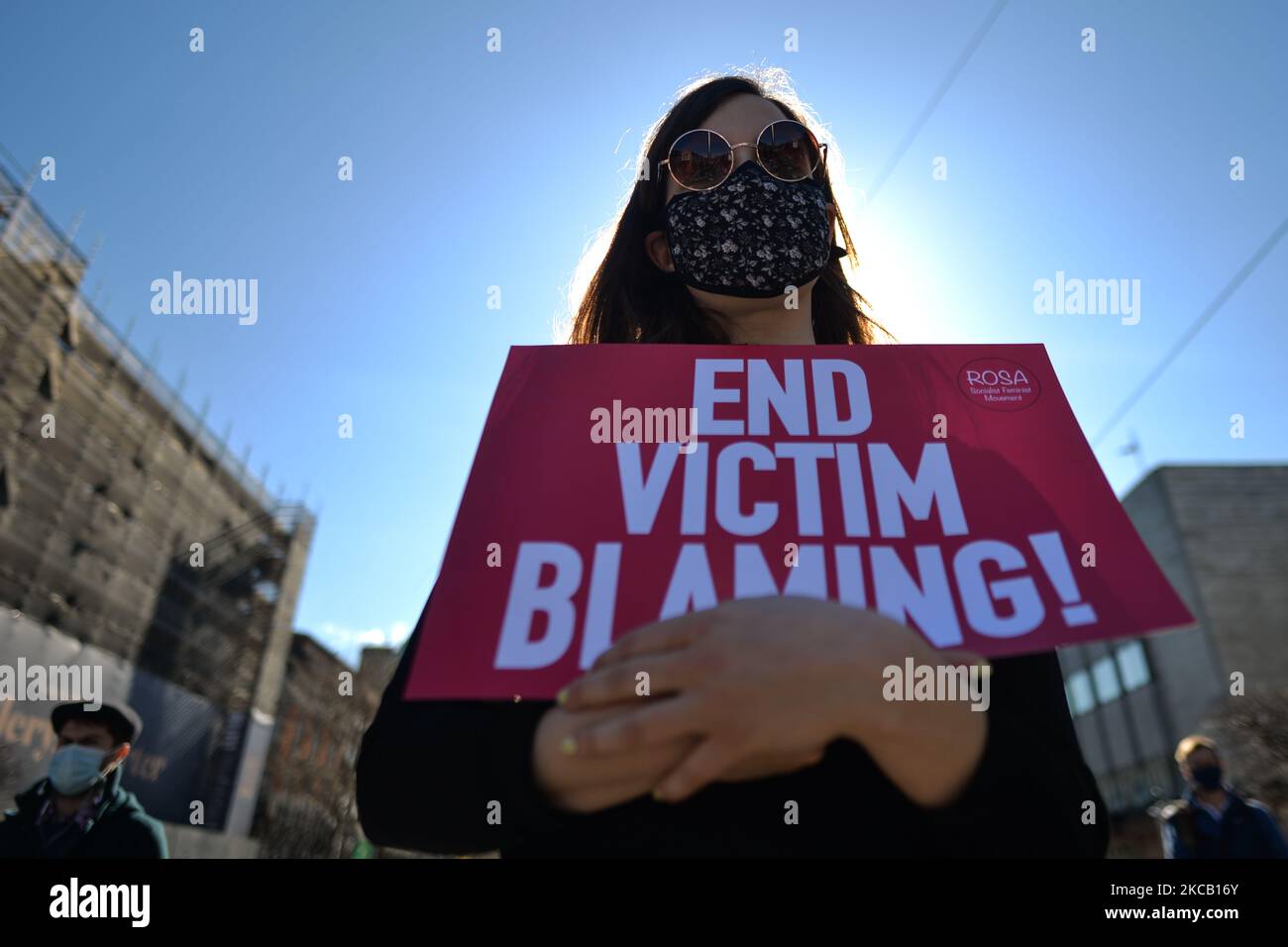 An activist holds a placard reading 'End Victim Blaming!' during a solidarity protest with women in the UK against gender-based violence seen on O'Connell Street in Dublin. The tragic killing of 33-year-old Sarah Everard in London sparked outrage among women in Britain, Ireland and across the world. Activists demand further action to combat violence against women. On Tuesday, 16 March 2021, in Dublin, Ireland. (Photo by Artur Widak/NurPhoto) Stock Photo