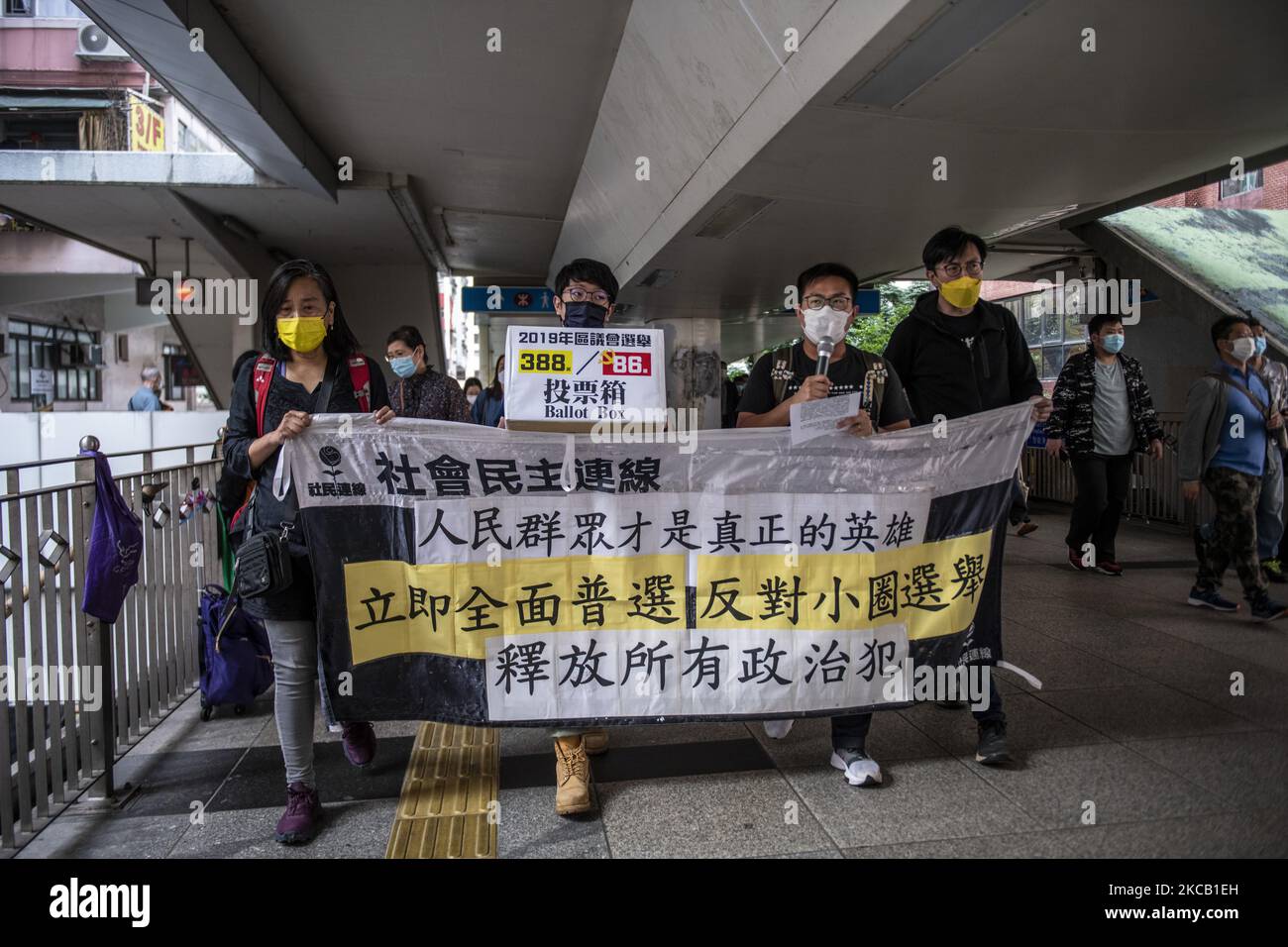 Pro-Democracy protesters hold up a banner in protest of the NPC's decision to 'improve' Hong Kong's Election system during a protest in Hong Kong, Wednesday, March 17, 2021.The Chinese Government has organized a three day Event to 'collect advice and suggestions' from HKSAR Government and representatives of different sectors in Hong Kong. (Photo by Vernon Yuen/NurPhoto) Stock Photo